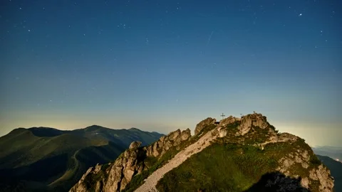 Timelapse of Starry Night Sky with Star Above Mountain Peak with Cross in Vidéo 316035076