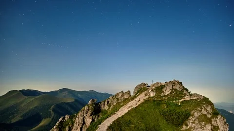 Timelapse of Starry Night Sky with Star Above Mountain Peak with Cross in Stock-Footage 317642463