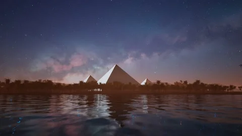 Timelapse of the starry sky over the lake and ancient pyramids on the horizon. Stock Footage 201129580