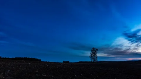 Timelapse of starry sky over plowed field. Stock Footage 79623797