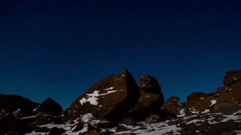 Timelapse of starry sky over snowy sandstone rocks at evening Stock Footage 73011474