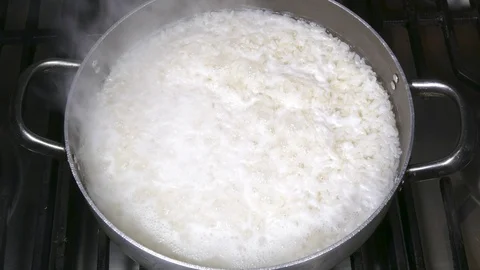 Timelapse – Steaming rice in an open pan. Stock Footage 129137209