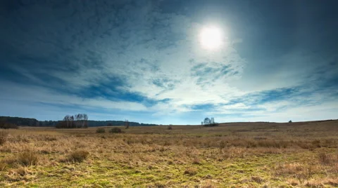 Timelapse of steppe landscape with withered grass at spring under cloudy sky and Stock Footage 61113935