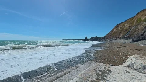 Timelapse steps to pebble beach gentle white surd blue skies summer Copper Coast Stock Footage 339382021