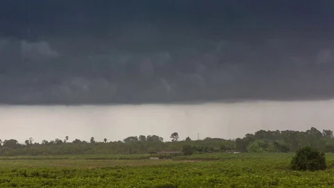 Timelapse storm and raining over green field Stock Footage 80663185
