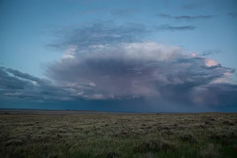 Timelapse of storm cell with lighting flows away across sage of prairie Stock Footage 62053978