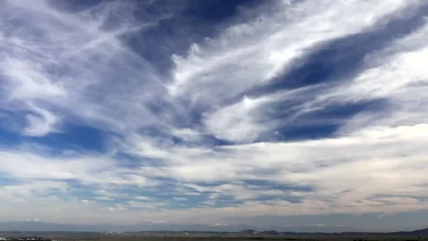 Timelapse storm clouds and cirrus drift across blue sky - Cultivation and Soil Stock Footage 339482692