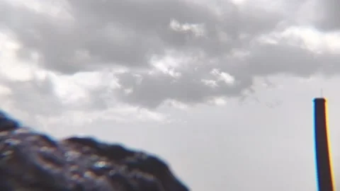 Timelapse of Storm Clouds with Blurred Rock and Chimney in Foreground Video stock 331596863