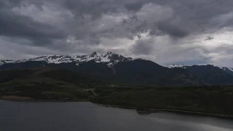 Timelapse of Storm Clouds Gathering Over Snow Covered Peaks and Dillon Reservoir Stock Footage 258154830