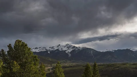 Timelapse of Storm Clouds Gathering Over Snow Covered Mountain Peaks Stock Footage 258163639