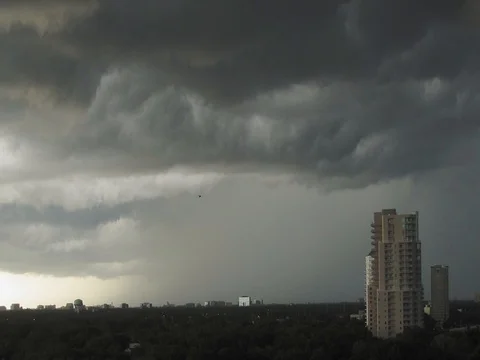 Timelapse Storm Rolling in Over High Rise Condo and tree covered city Stock Footage 82053183