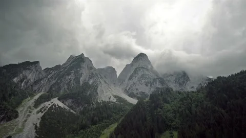 Timelapse of stormy clouds gather around the mountain peaks Stock Footage 121484037