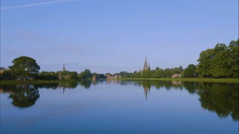 TImelapse Stowepool of Three Spires Cathedral Across a Lake Stock Footage 113485711
