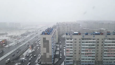 Timelapse street in city. View from window. Snowing. Stock Footage 130364050