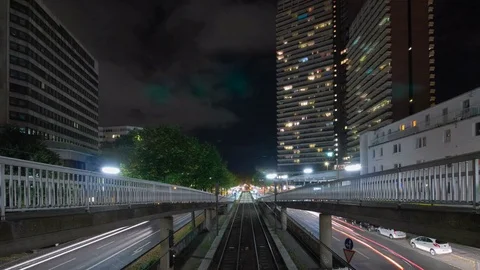 Timelapse of subway at night in front of high buildings skyscraper in city Stock Footage 72848291