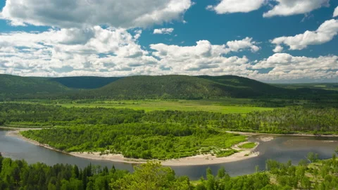 Timelapse. Summer valley landscape with river, hills, running clouds Stock Footage 132711321