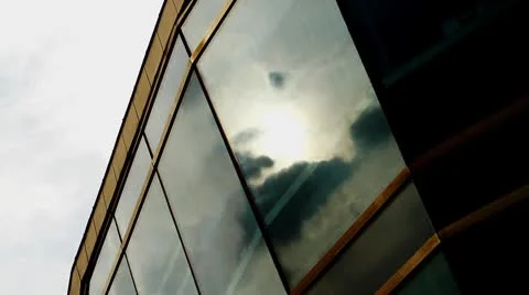 Timelapse of sun and dark clouds reflected on windows Stock Footage 8954591
