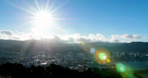 Timelapse of sun bearing down over city in New Zealand Stock Footage 98486885