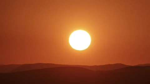 Timelapse of sun close-up rising over mountain horizon.  Stock Footage 305159487