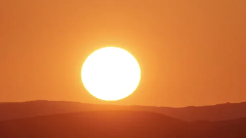 Timelapse of sun close-up rising over mountain horizon.  Stock Footage 305159677