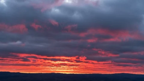 Timelapse of sun disappearing beneath the clouds at sunset Stock Footage 114349255