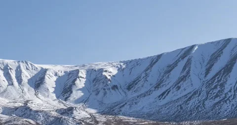 Timelapse of sun movement on crystal clear sky over snow mountain top. Yellow Stock Footage 155082785