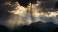 Timelapse Of Sun Rays Emerging Though The Dark Storm Clouds In The Mountains Stock Footage