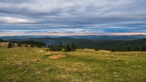 Timelapse of sun rays emerging though the dark storm clouds in the mountains Stock Footage 121814692