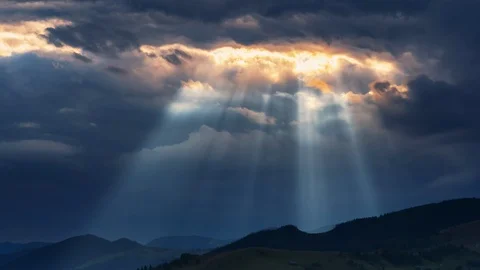 Timelapse of sun rays emerging though the dark storm clouds Stock Footage 124527115
