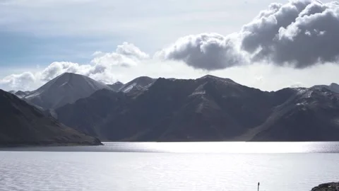 Timelapse of sun rays emerging though the dark storm clouds in the mountains Stock Footage 153512178