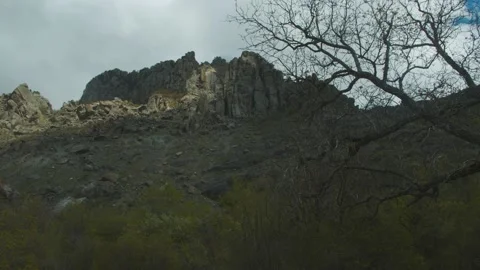 Timelapse of sun rays emerging though the dark storm clouds in the mountains Stock Footage 156446600