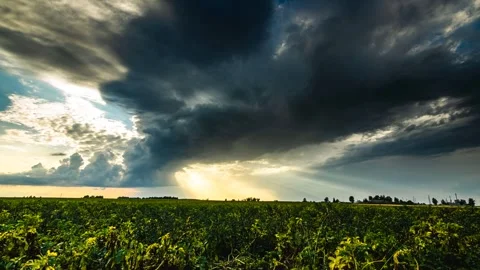 Timelapse of Sun Rays Emerging Though the Dark Storm Clouds in the Fields Stock Footage 280743152