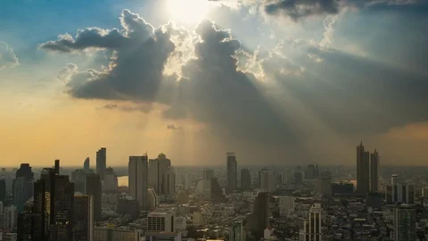 Timelapse, sun rays light beam through the clouds to the Business city area Stock Footage 121726569