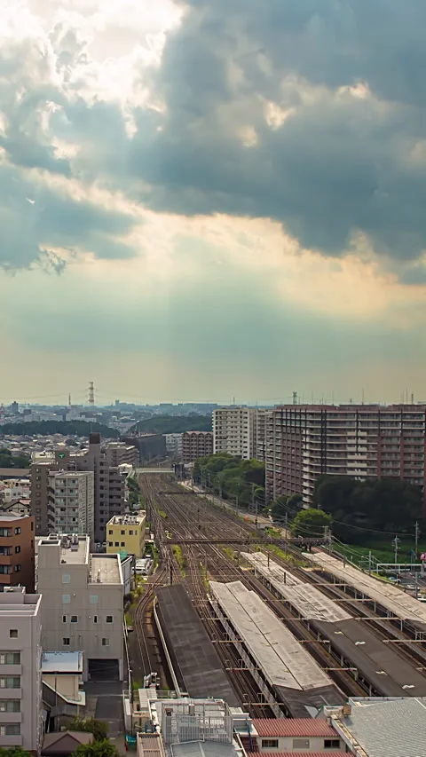 Timelapse of sun rays over Abiko Station railway tracks in Japan vertical video Stock Footage 341597314