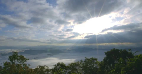 Timelapse of sun rays through the clouds and beautiful mist Stock Footage 254042768