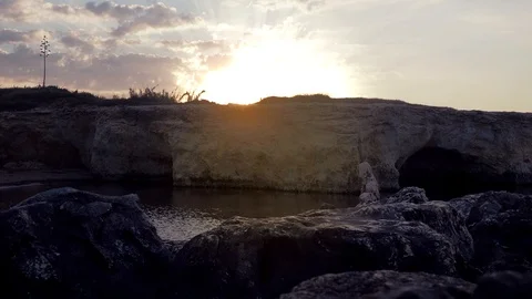 Timelapse of the sun rising behind the rocks at the Cirica Bay, Italy, 4K Stock Footage 113125965