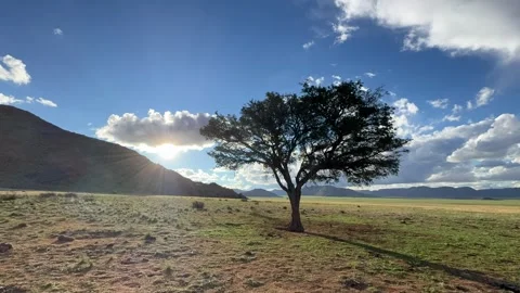 Timelapse of sun setting behind Tiras mountains with movings clouds Stock Footage 334935491