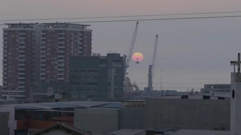 Timelapse of sun setting in the Pacific Ocean behind buildings Stock Footage 81884774