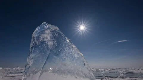 Timelapse of sun trough transparent ice floe on frozen lake Stock Footage 177302198