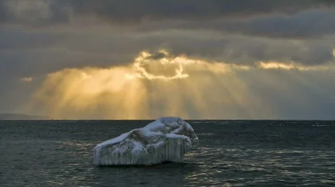 Timelapse of sunbeams over ice berg Stock Footage 310445