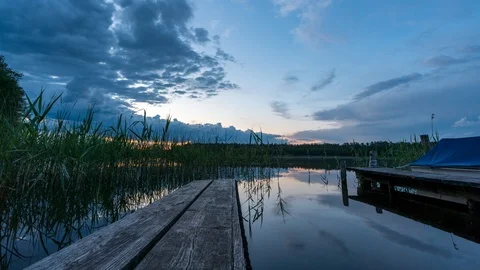 Timelapse Sundown on lake Schaalsee. In motion with pier in front. Stock Footage 119924896