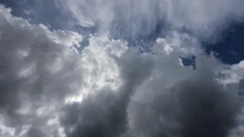 Timelapse of sunlight covered by dark clouds in the blue sky Stock Footage 307417151