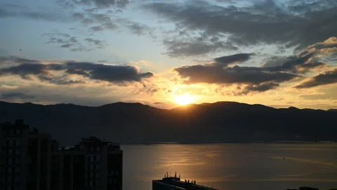 Timelapse of sunrise from behind mountains on a bay ProRes 4K Stock Footage 164200375