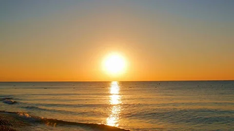 Timelapse sunrise, from dark to bright day sun, over sea, waves are washing Stock Footage