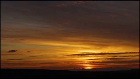 Timelapse of Sunrise on the field with clouds in the sky and orange red tones. Stock Footage 183266898