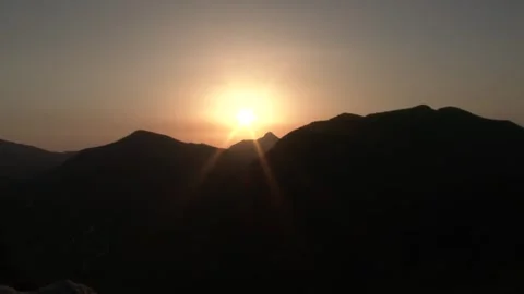 Timelapse sunrise forms above mountain peaks as sea - Open Slopes and Sky Color Stock Footage 339792669