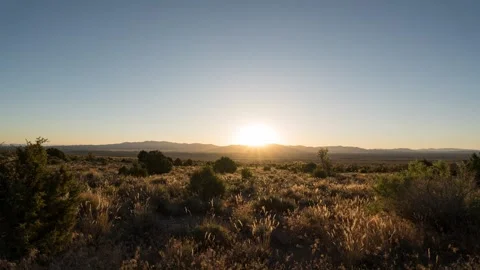 Timelapse of the sunrise over mountains and field of grass in 4k Stock Footage 338097244