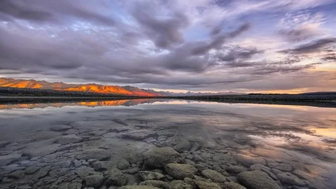 Timelapse of Sunrise reflected in mirror pond Southern Alps in background Stock Footage 73844297