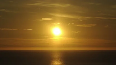 Timelapse of a sunset in 4K - The sun disappears behind the horizon. Stock Footage 51516431