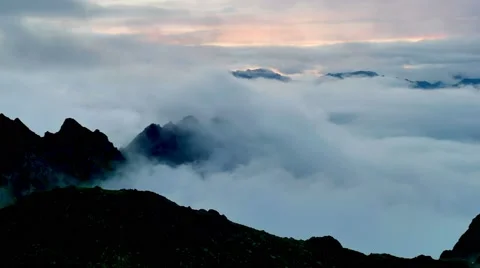 Timelapse of sunset above the clouds with silhouettes of mountain tops Stock Footage 65763074